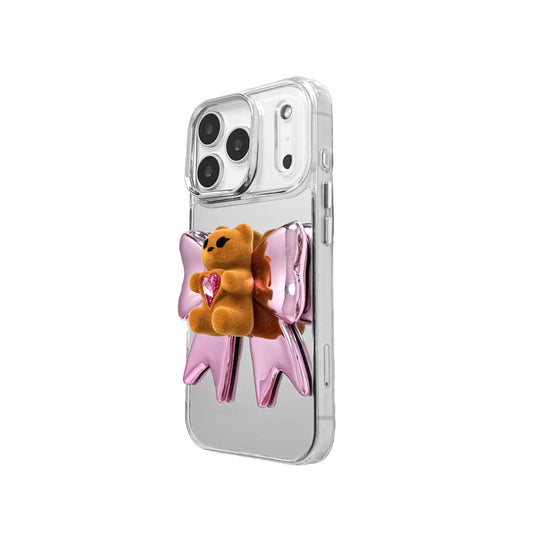 Bow Magic Bear iPhone Case - Pink Edition featuring a beige gummy bear holding a pink crystal heart, set against a metallic pink bow design.