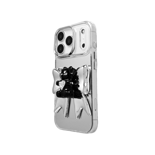 Bow Magic Bear iPhone Case featuring a glossy black gummy bear holding a clear crystal heart, set against a large metallic silver bow design.