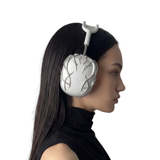 Person wearing a futuristic silver headpiece with tree-like design on a plain background