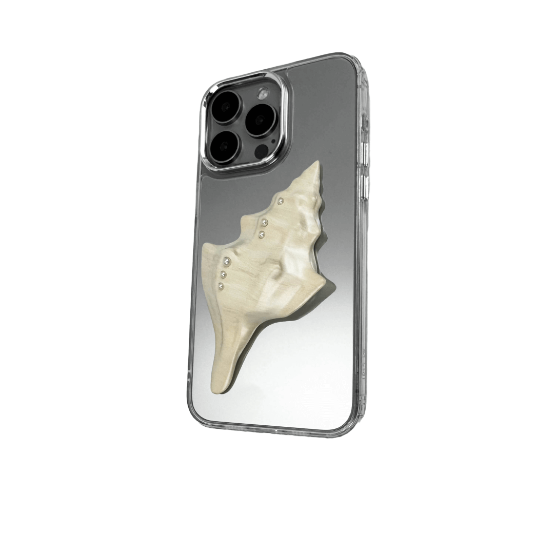 Metallic seashell-shaped phone case accessory with a sculpted, fluid spiral design and delicate pearl-like embellishments.