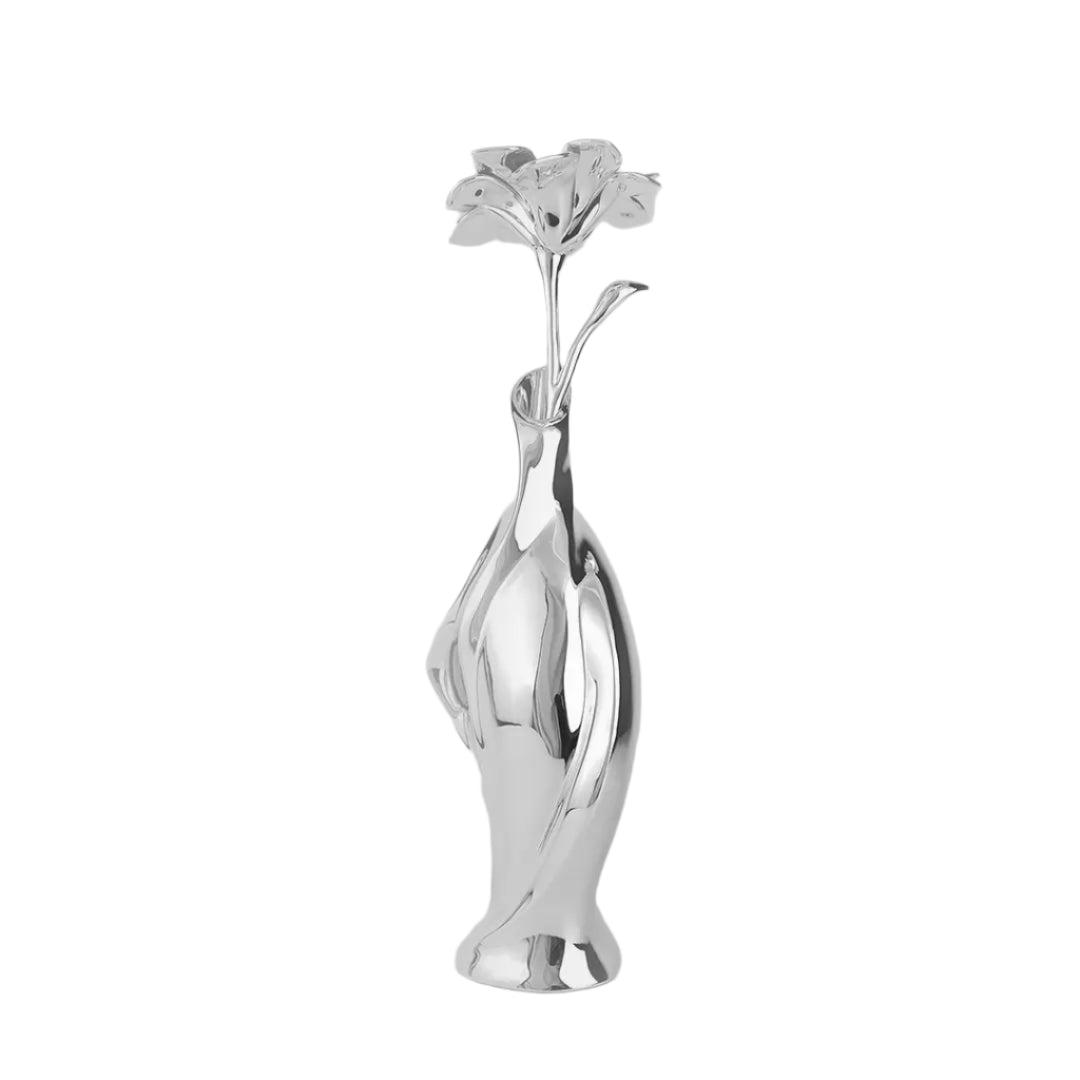 Futuristic silver vase with fluid sculptural form and blooming lily – sleek metallic design blending natural elegance and modern artistry