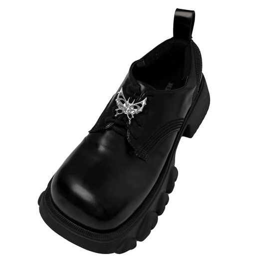 A silver metallic filigree butterfly shoelace charm with intricate openwork details, adding elegance and a luxurious accent to sneakers.