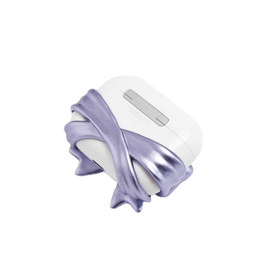 PURPLE GEM BOW AIRPODS COVER LIMITED. White AirPods case wrapped with a 3D metallic-look violet bow featuring a central purple gem.