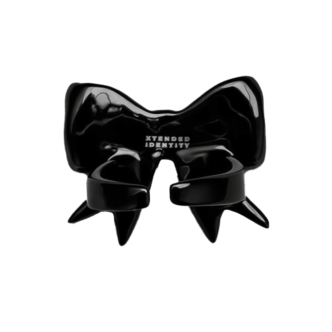 Stylish ribbon-shaped ring in silver and black with a pink Swarovski crystal accent.