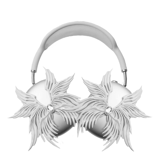 A high-fashion 3D attachment for AirPods Max headphones featuring layered, symmetrical Seraphim angel wings with a central white Swarovski crystal on each ear cup. Shown in two finish options: Reflective Silver Chrome and Matte Ethereal White.