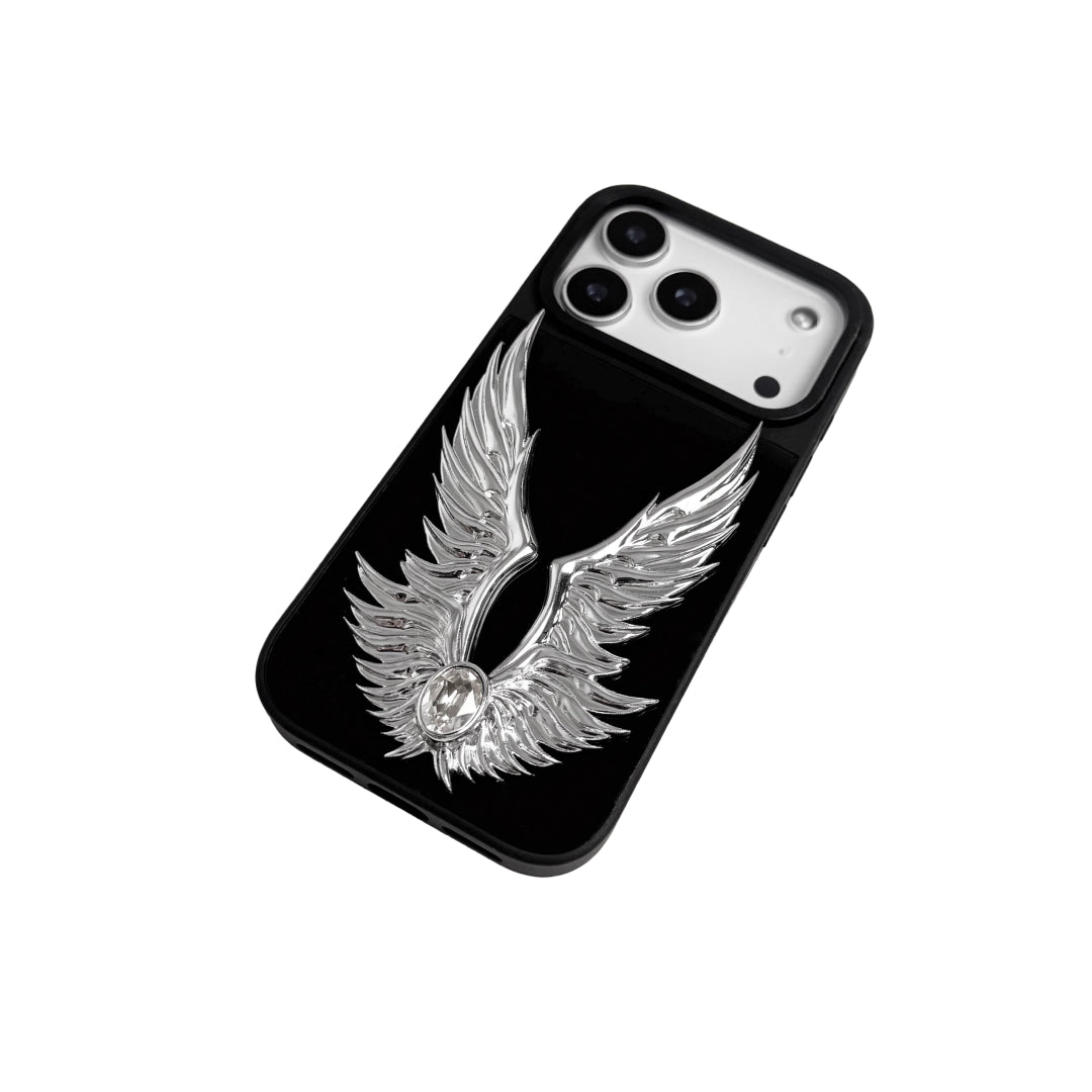 The Gem Silver Angel Wings iPhone Case featuring symmetrical 3D sculpted silver wings with a central rhinestone. Shown with both White and Black gem options, available on Silver, Transparent, and Black case bases.