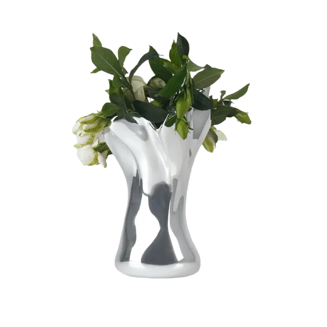 Futuristic chrome vase with flowing sculptural petal design – organic metallic form inspired by blooming lilies