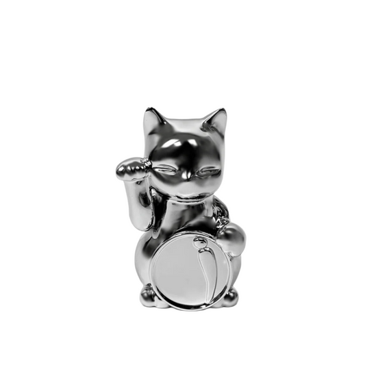 Futuristic chrome Maneki-neko sculpture – reflective silver lucky cat figure with raised paw and coin, blending traditional symbolism with modern minimalist form