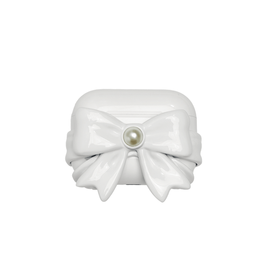 A pair of protective covers for Apple AirPods (or AirPods Pro) charging case. Each cover is white and features a large, 3D sculpted bow charm centered on the front. One bow is glossy black and the other is pure white, with a single white pearl embedded in the center of each.