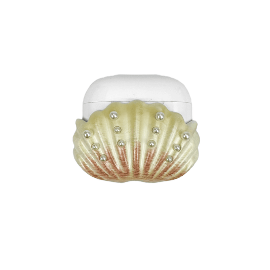 Shell-shaped headphone accessory with flowing ridges and embedded pearl-like orbs, designed to wrap around the device in a soft, ocean-inspired form.