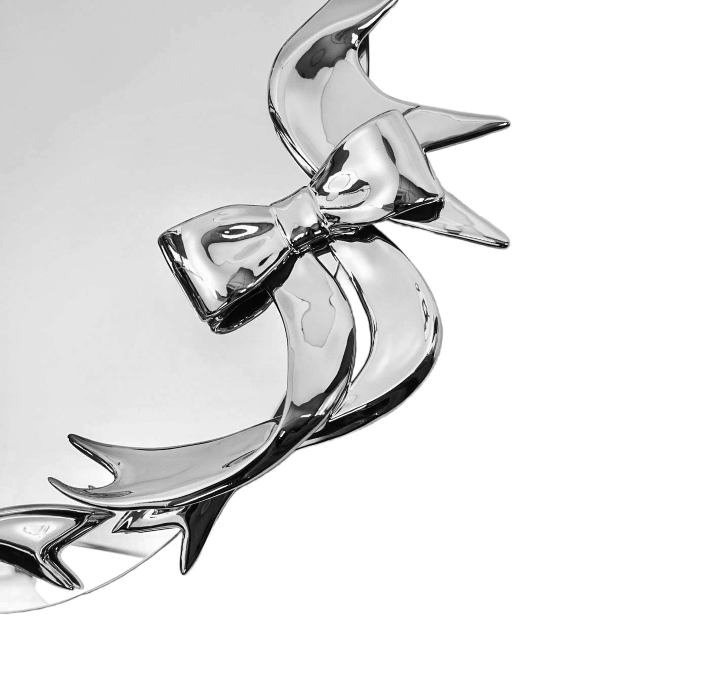 Futuristic 3D ribbon mirror in glossy pink chrome – sculptural bow-and-streamer frame surrounding an oval reflective surface with playful baroque flair