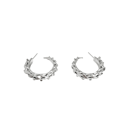 Wrap your ears in anatomical art with this luxury Spine Hoop Earrings M. Vertebra-inspired hoops for edgy stacking.