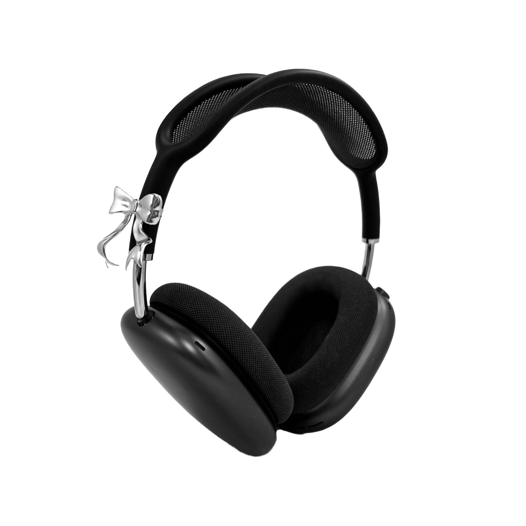 Polished silver bow-shaped accessory attached to the side of black AirPods Max headphones.