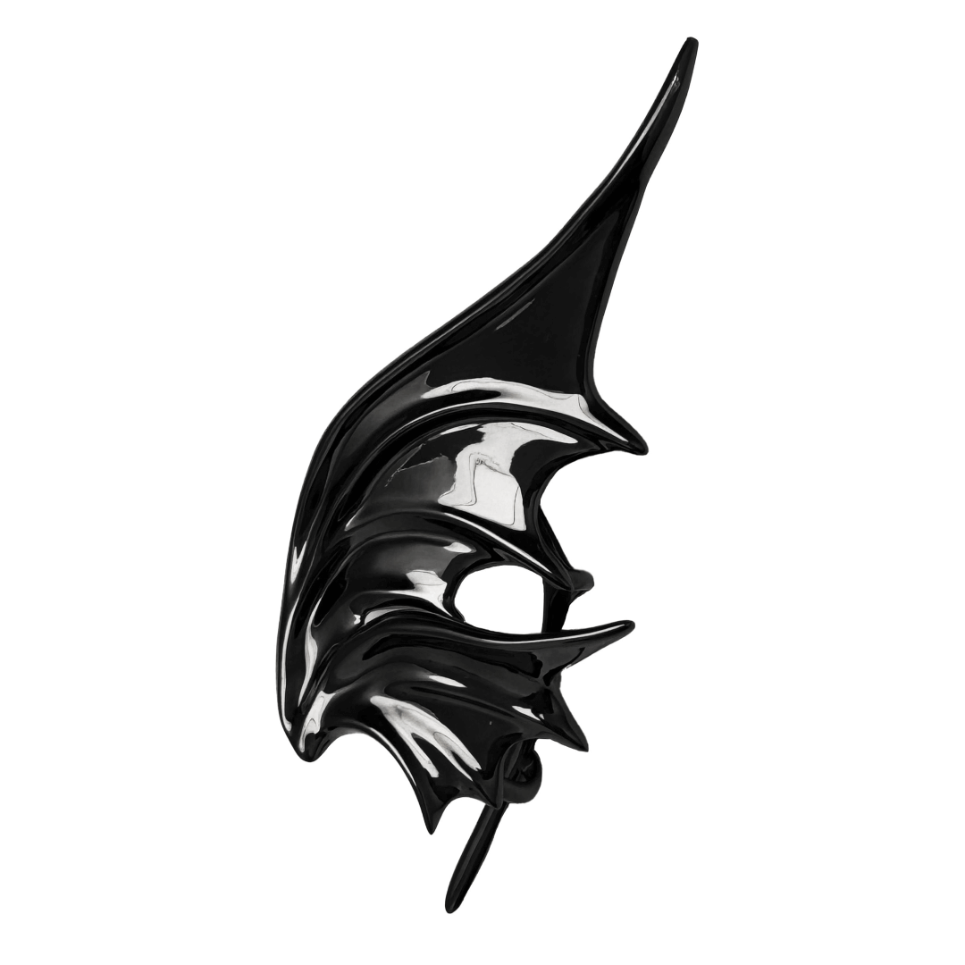 Sculptural silver ear cuffs shaped like siren-inspired wings, with a bold and futuristic design.