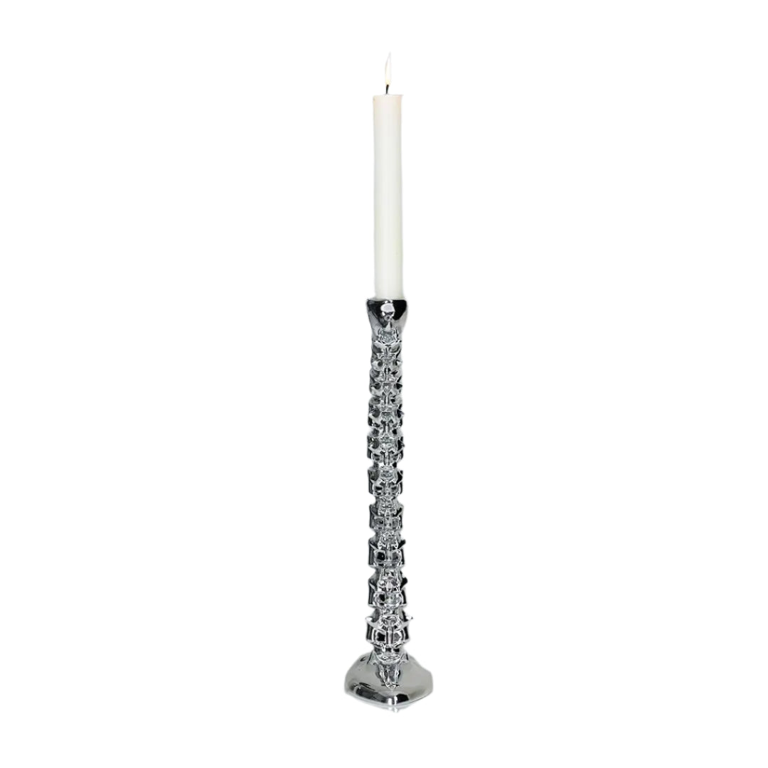Futuristic chrome candleholder in biomorphic spinal-column form – sculptural vertebrae base studded with tiny climber figures ascending its curved backbone