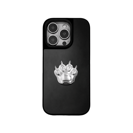 A high-fashion iPhone case featuring a miniature 3D sculpted cat paw in a reflective silver chrome finish. The design is shown in three variations: a Reflective Silver base, a Sleek Black base, and a Clear Transparent base, all accented by the metallic silver paw ornament.