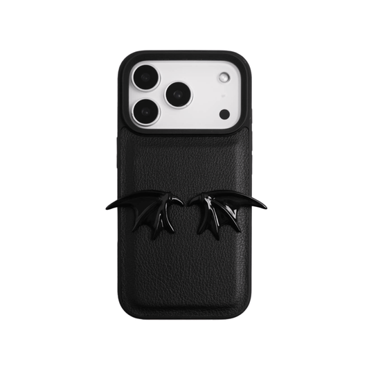 The Tiny Demon Wings iPhone Case featuring a pair of small, symmetrical 3D sculpted black bat-style wings on the lower portion of the case. Available in two base options: Crystal Clear (Transparent) and Black Lychee Leather.