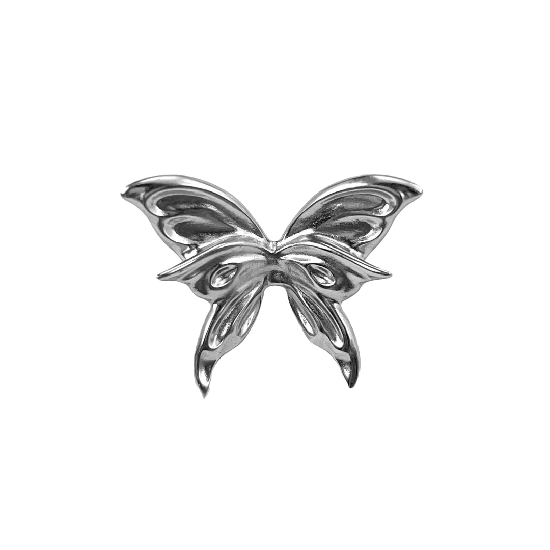 Chrome butterfly shoe accessory clipped onto the laces or vamp of a black sneaker or leather shoe.