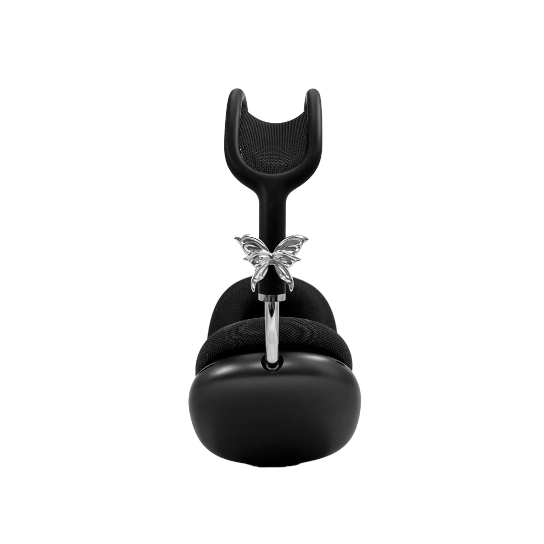 Chrome butterfly-shaped decorative accessory attached to AirPods Max.