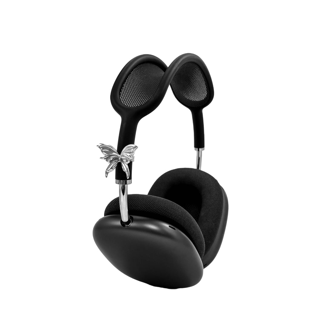 Chrome butterfly-shaped decorative accessory attached to AirPods Max.