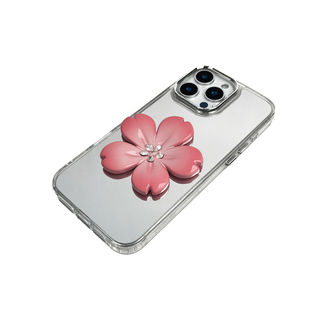 Silver mirror-finish iPhone case decorated with a cherry blossom flower in pink and silver tones, accented by five sparkling crystals for an elegant, luxurious look.