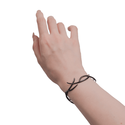 Hand wearing a black bracelet on a transparent background