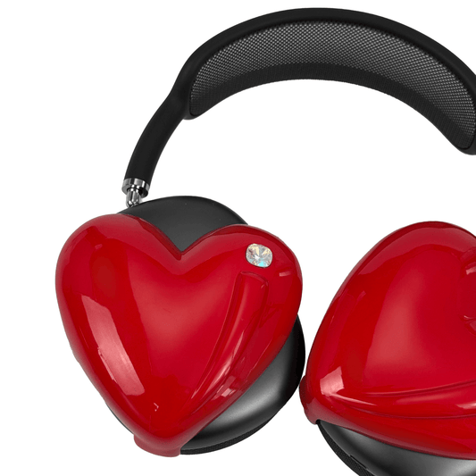 Metallic heart-shaped AirPods Max cover in silver, pink, red and black, with a smooth 3D sculpted surface and a single crystal stud detail.
