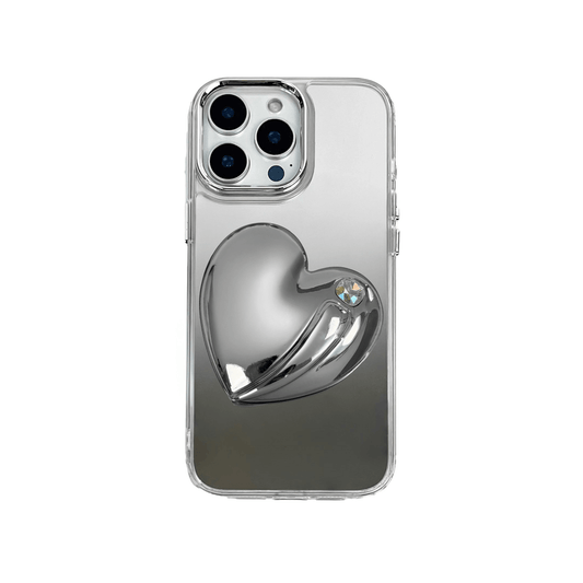 Metallic silver, pink, red, black iPhone case with a large sculpted heart in 3D, featuring a shiny chrome finish and a single gem-like detail.