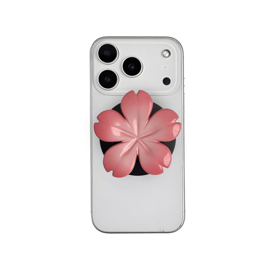Magnetic phone grip with a silver mirror finish, decorated with a pink and silver cherry blossom flower for an elegant floral look.