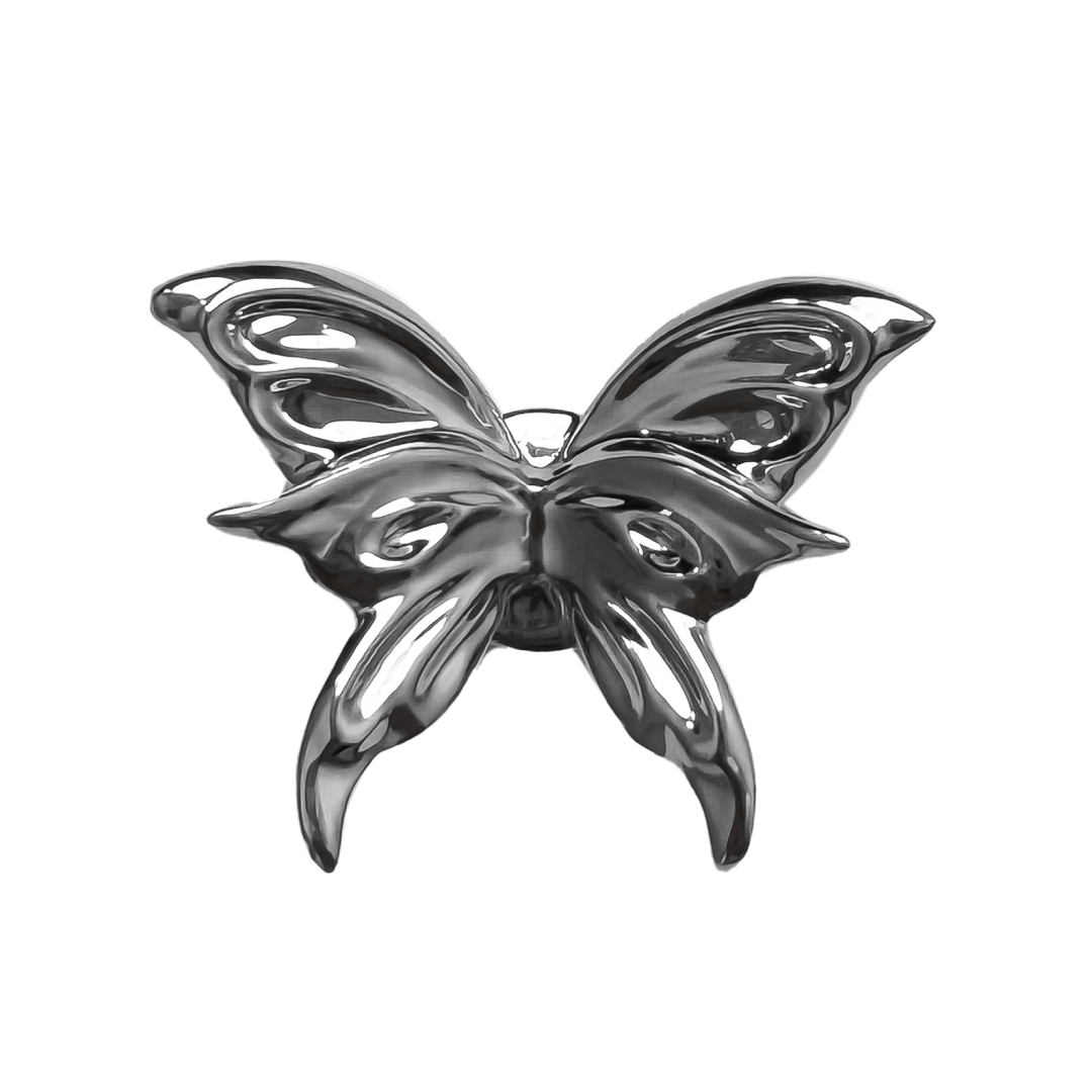 A silver metallic 3D butterfly shoelace charm with raised wings, creating a sculptural and dynamic look on sneakers.