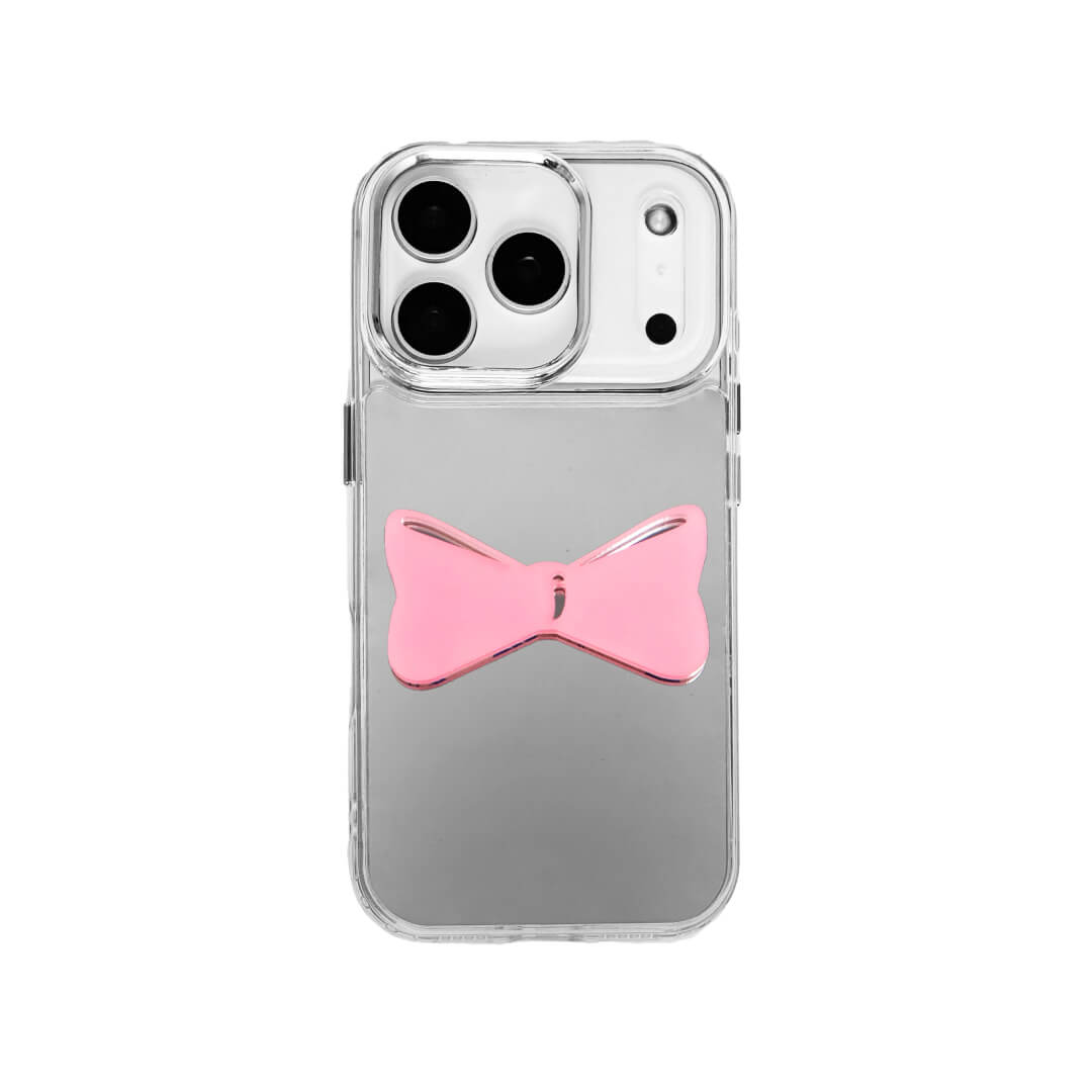 A modern iPhone case featuring a 3D acrylic bow/ribbon ornament. Available in Sakura Pink and Azure Blue acrylic finishes. The case is shown on both a Reflective Silver metallic base and a Clear Transparent base, showcasing a minimalist yet playful fashion aesthetic.