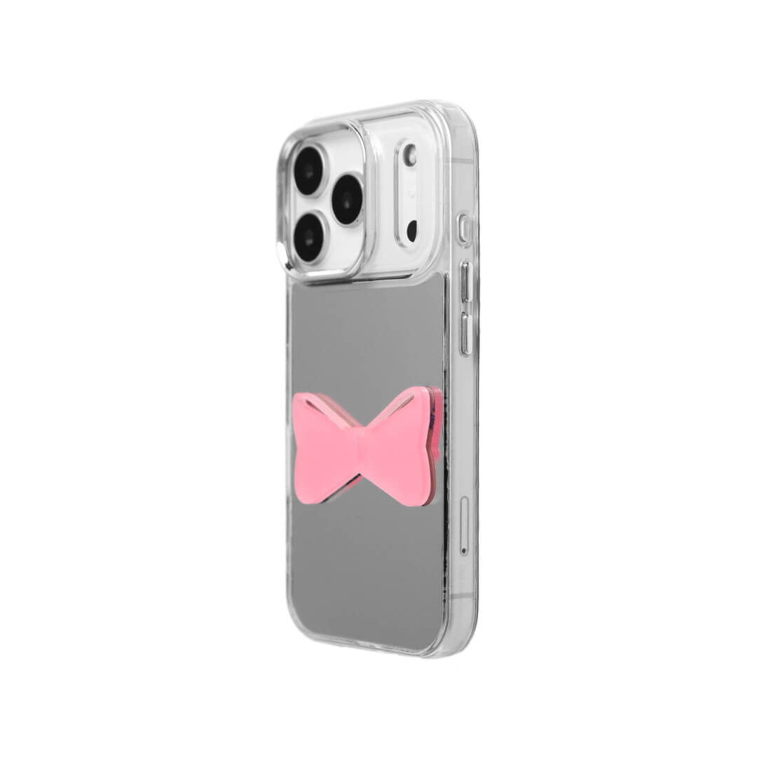 A modern iPhone case featuring a 3D acrylic bow/ribbon ornament. Available in Sakura Pink and Azure Blue acrylic finishes. The case is shown on both a Reflective Silver metallic base and a Clear Transparent base, showcasing a minimalist yet playful fashion aesthetic.