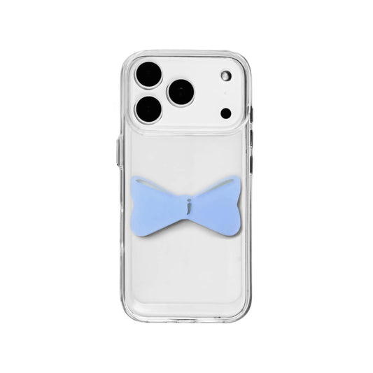 A modern iPhone case featuring a 3D acrylic bow/ribbon ornament. Available in Sakura Pink and Azure Blue acrylic finishes. The case is shown on both a Reflective Silver metallic base and a Clear Transparent base, showcasing a minimalist yet playful fashion aesthetic.