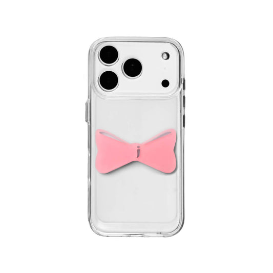 A modern iPhone case featuring a 3D acrylic bow/ribbon ornament. Available in Sakura Pink and Azure Blue acrylic finishes. The case is shown on both a Reflective Silver metallic base and a Clear Transparent base, showcasing a minimalist yet playful fashion aesthetic.