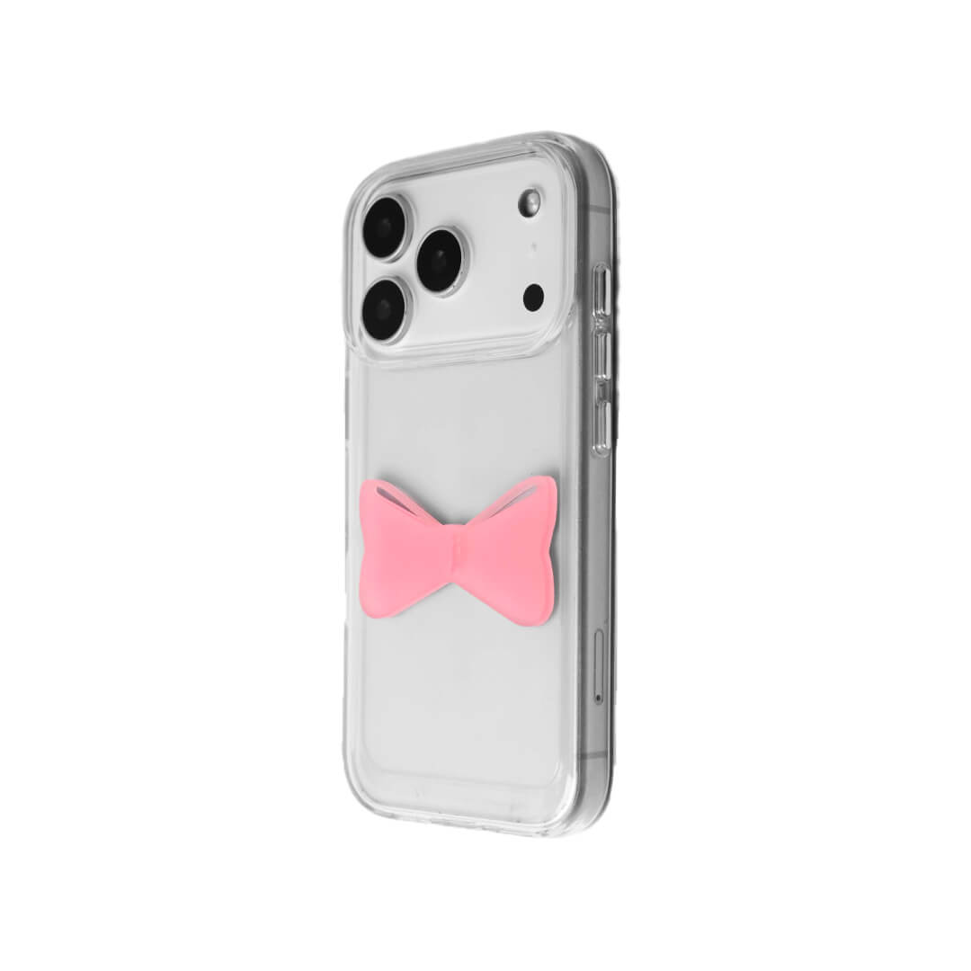 A modern iPhone case featuring a 3D acrylic bow/ribbon ornament. Available in Sakura Pink and Azure Blue acrylic finishes. The case is shown on both a Reflective Silver metallic base and a Clear Transparent base, showcasing a minimalist yet playful fashion aesthetic.