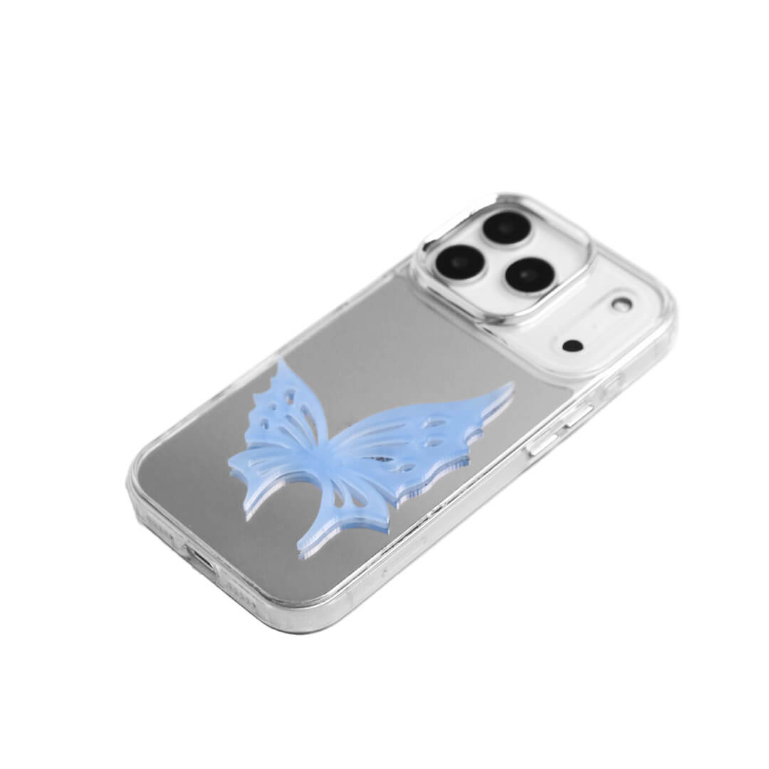 A luxury iPhone case featuring a large 3D acrylic butterfly ornament with delicate wing cutouts. Available in two translucent colors: Sakura Pink and Azure Blue. The butterfly is mounted on a Clear Transparent base, creating a romantic and ethereal floating effect.
