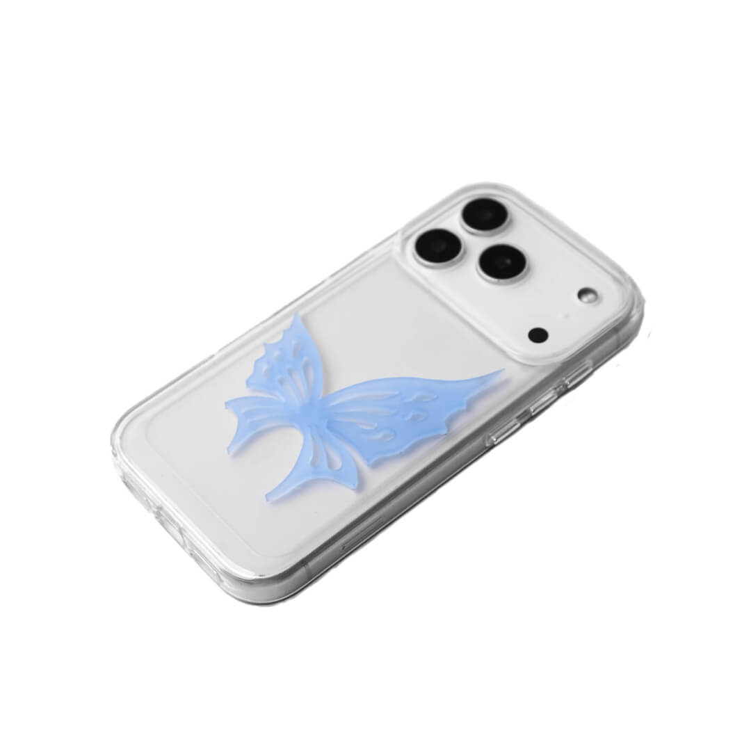 A luxury iPhone case featuring a large 3D acrylic butterfly ornament with delicate wing cutouts. Available in two translucent colors: Sakura Pink and Azure Blue. The butterfly is mounted on a Clear Transparent base, creating a romantic and ethereal floating effect.