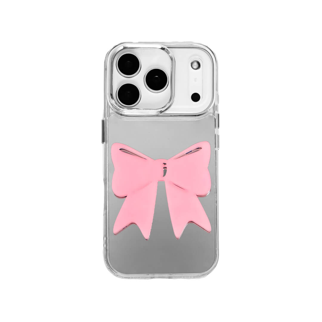 A modern iPhone case featuring a 3D acrylic ribbon ornament with long, flowing tails. Available in Sakura Pink and Azure Blue finishes. The case is shown on both a Reflective Silver metallic base and a Clear Transparent base, showcasing a minimalist yet playful fashion aesthetic.