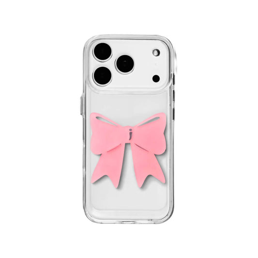 A modern iPhone case featuring a 3D acrylic ribbon ornament with long, flowing tails. Available in Sakura Pink and Azure Blue finishes. The case is shown on both a Reflective Silver metallic base and a Clear Transparent base, showcasing a minimalist yet playful fashion aesthetic.