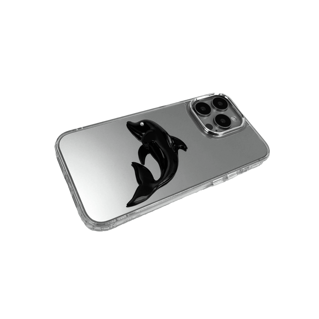 Matte phone case with a high-relief sculpted dolphin figure swimming diagonally across the back.