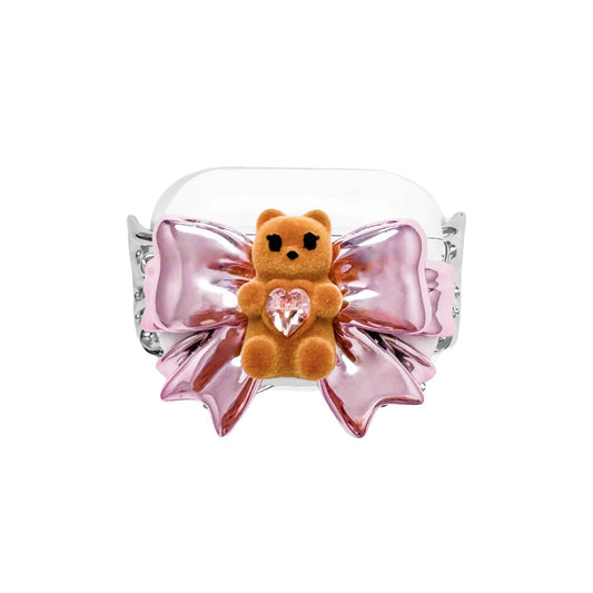 Bow Magic Bear AirPods Cover – Pink Edition featuring a beige gummy bear holding a pink crystal heart, centered on a metallic pink bow design.