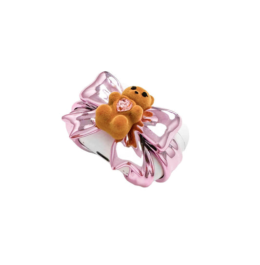 Bow Magic Bear AirPods Cover – Pink Edition featuring a beige gummy bear holding a pink crystal heart, centered on a metallic pink bow design.