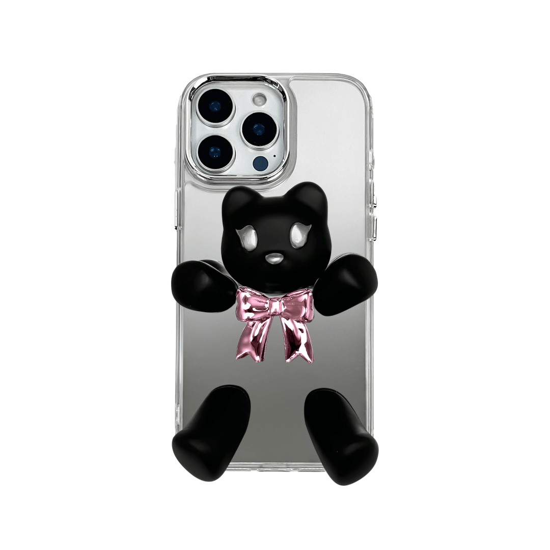 Transparent mirror phone case with a 3D teddy bear in brown flocking, wearing a black bow tie.