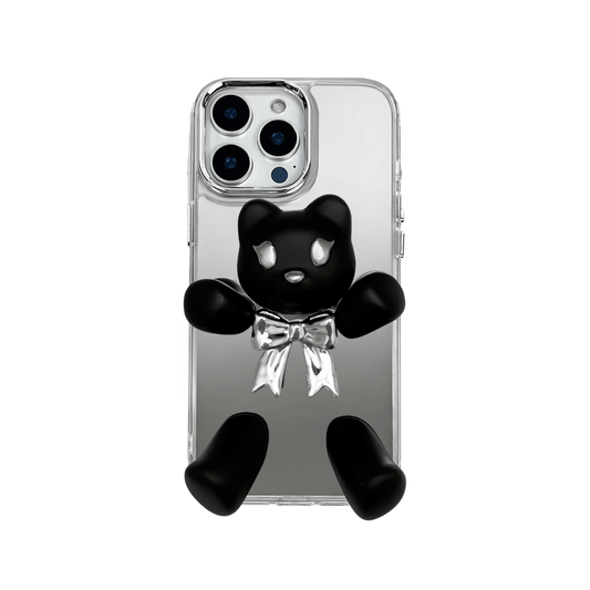 Transparent mirror phone case with a 3D teddy bear in brown flocking, wearing a black bow tie.