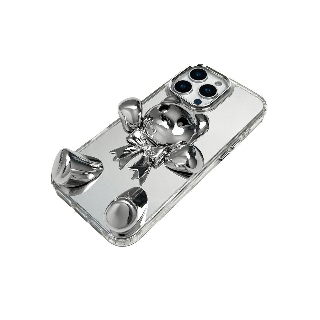 Transparent mirror phone case with a 3D teddy bear in brown flocking, wearing a black bow tie.