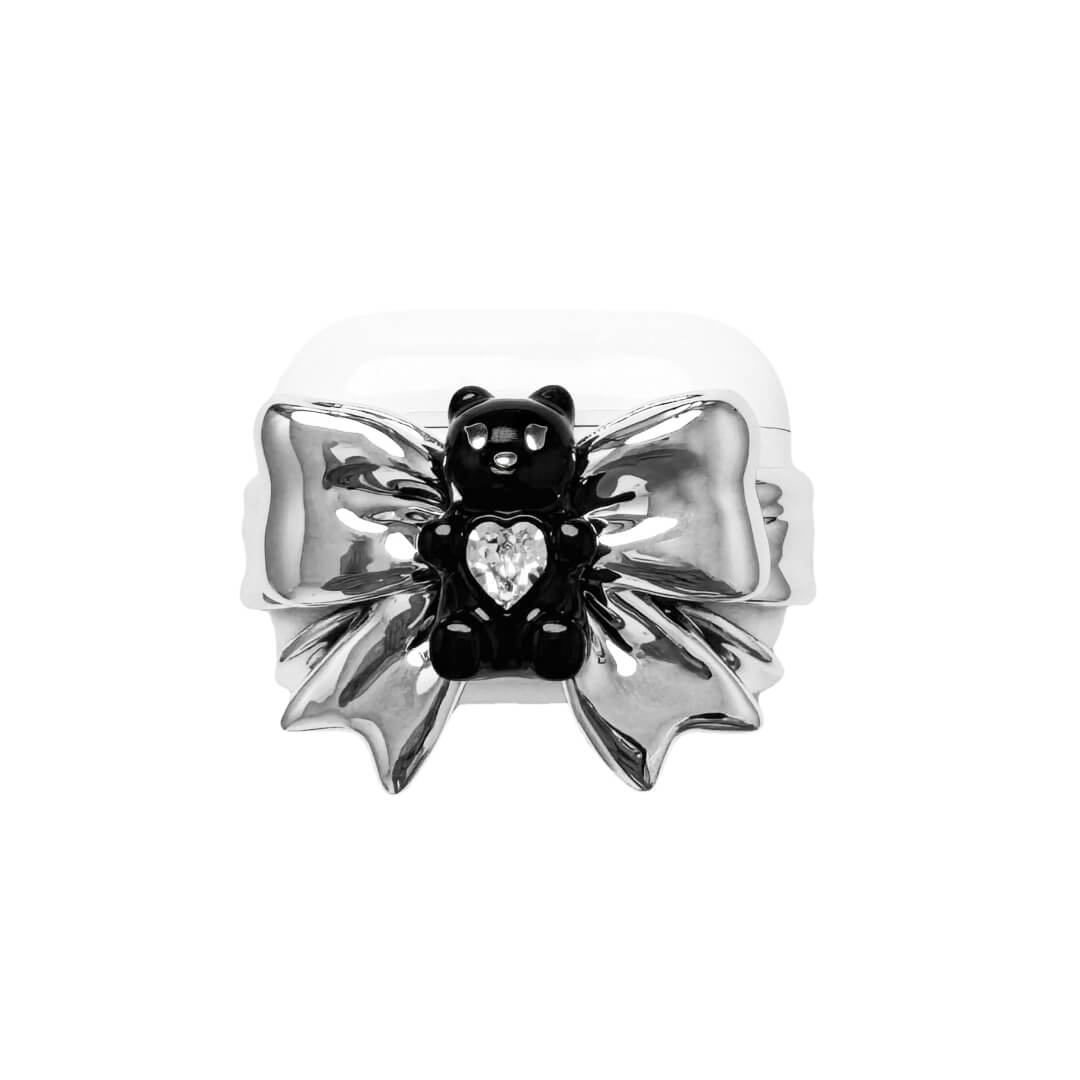 Bow Magic Bear AirPods Cover featuring a glossy black gummy bear holding a crystal heart, centered on metallic silver bow-shaped detailing.
