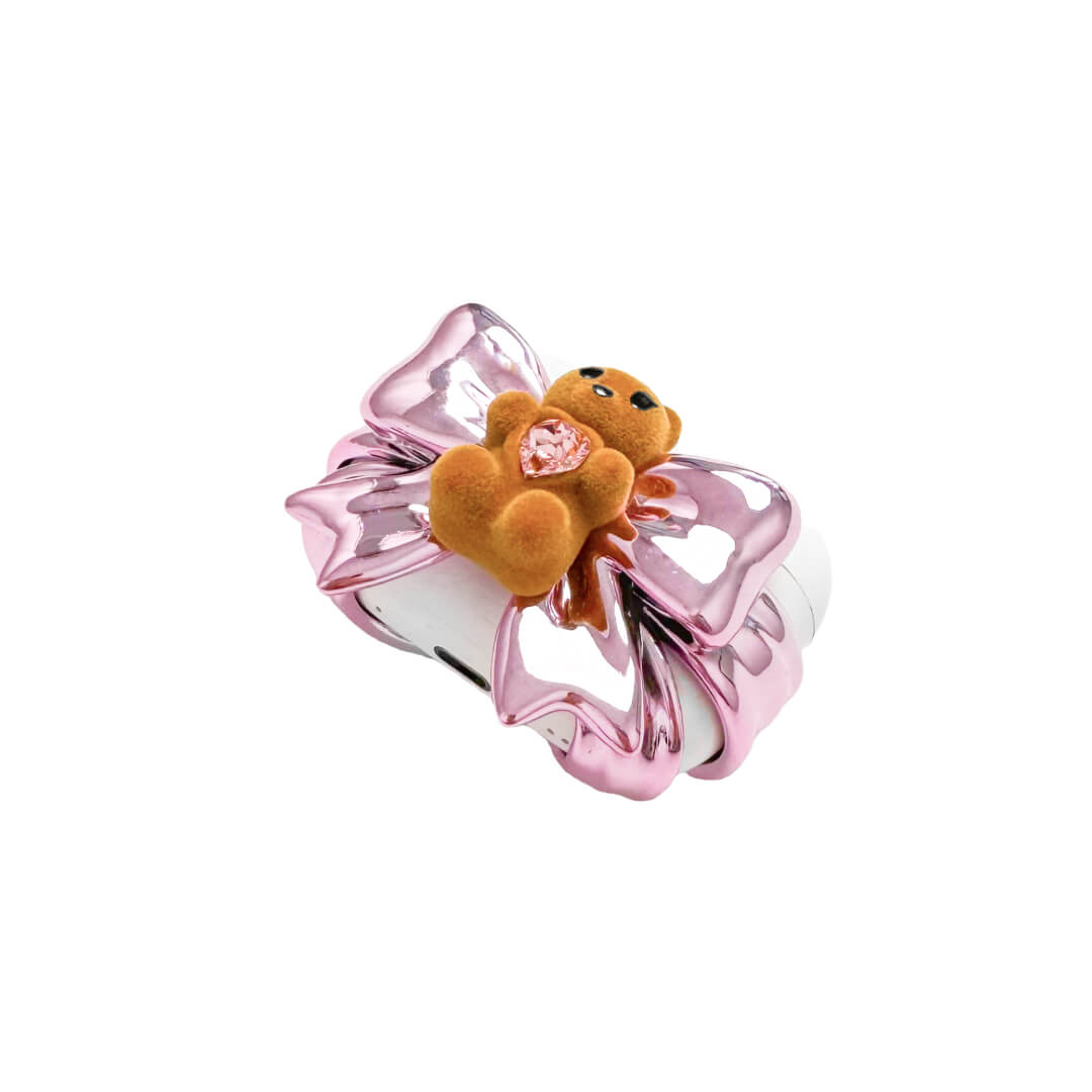 Bow Magic Bear AirPods Cover – Pink Edition featuring a beige gummy bear holding a pink crystal heart, centered on a metallic pink bow design.