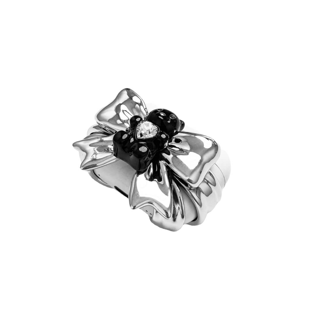Bow Magic Bear AirPods Cover featuring a glossy black gummy bear holding a crystal heart, centered on metallic silver bow-shaped detailing.