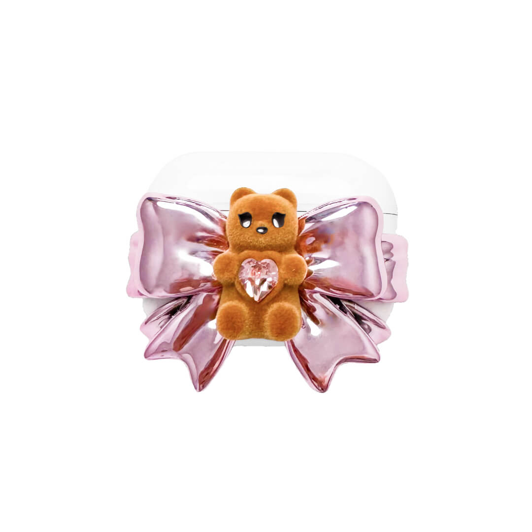 Bow Magic Bear AirPods Cover – Pink Edition featuring a beige gummy bear holding a pink crystal heart, centered on a metallic pink bow design.