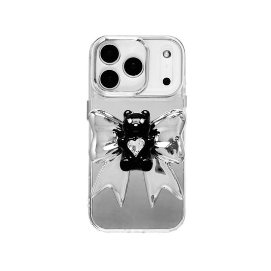 Bow Magic Bear iPhone Case featuring a glossy black gummy bear holding a clear crystal heart, set against a large metallic silver bow design.